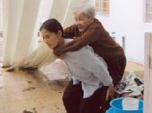Nun Assists Elderly Woman