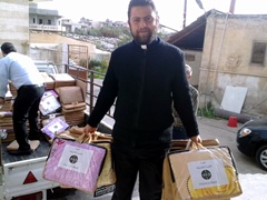 A priest distributes aid in Syria