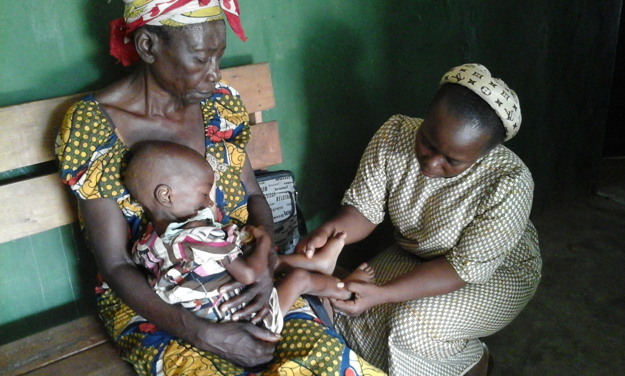 A sister helps a mother and child in DRC.jpg