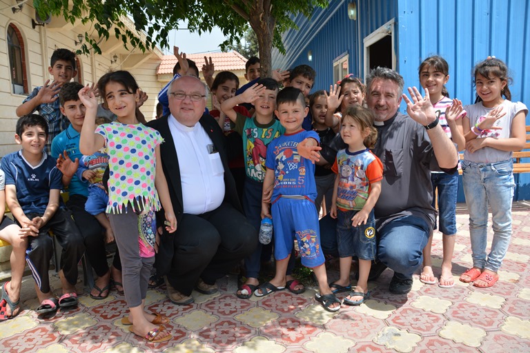 Father Halema (Center Left) meets Christian children in Kurd