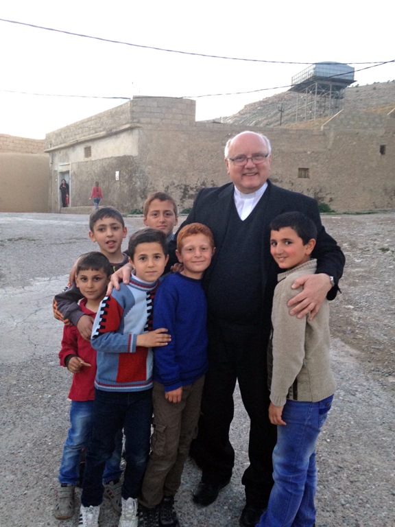 Father Halemba and young refugees.jpg