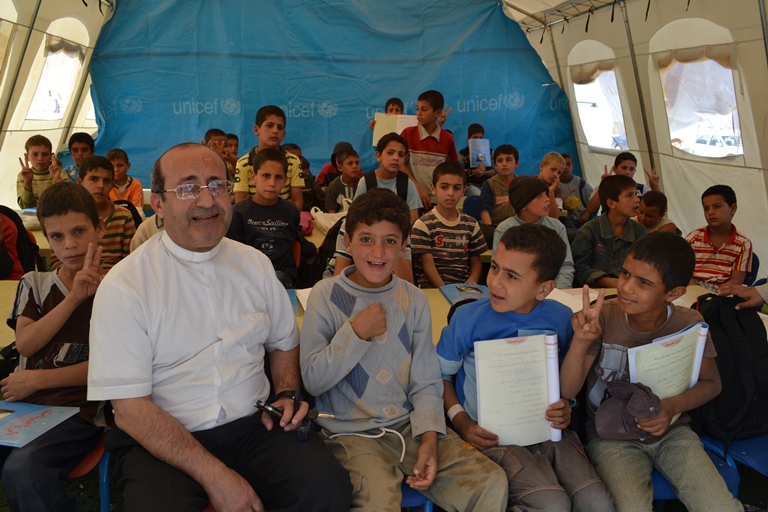 Father Jaar with Christian refugee children.jpg.2.jpg