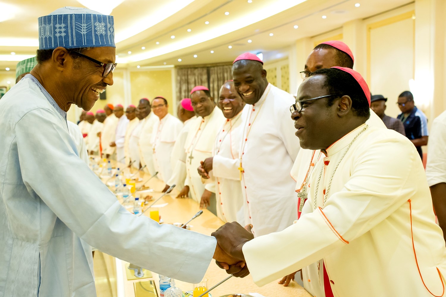 President Buhari greets Bishop Matthew Kukah.jpg